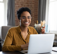 woman sitting at workplace with laptop